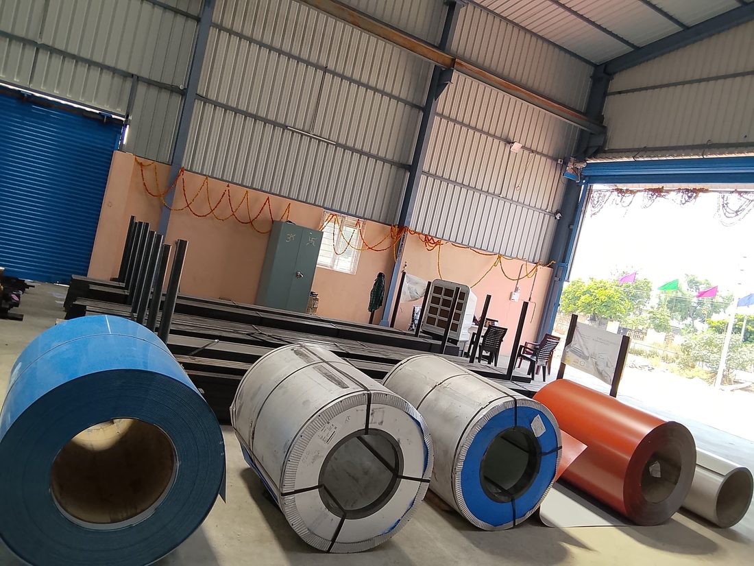 Colour-coated coil stock and pipe sections in our warehouse