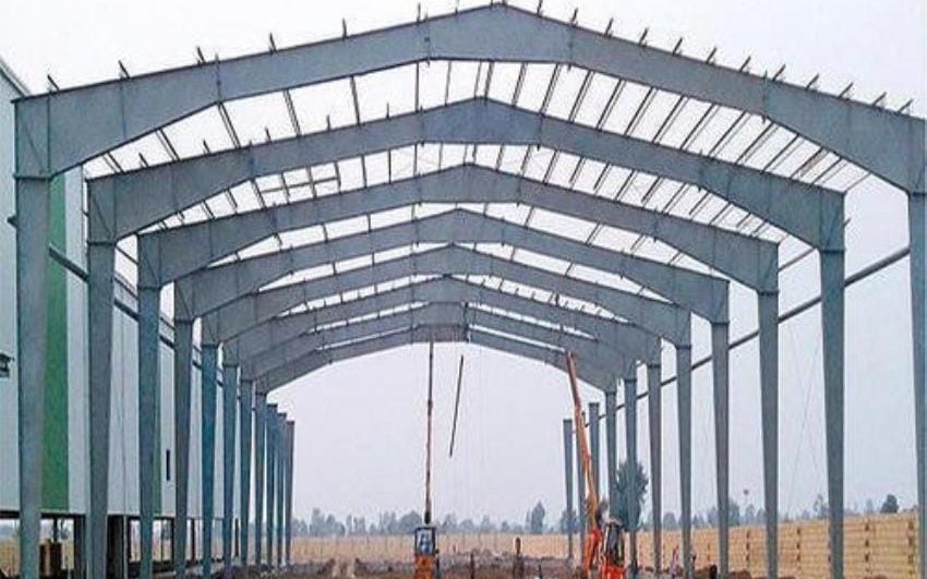 Interior view along a wide clear-span shed frame with no internal columns